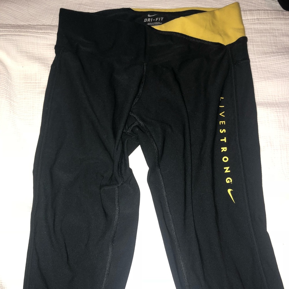 Black and yellow Nike Livestrong crop leggings.